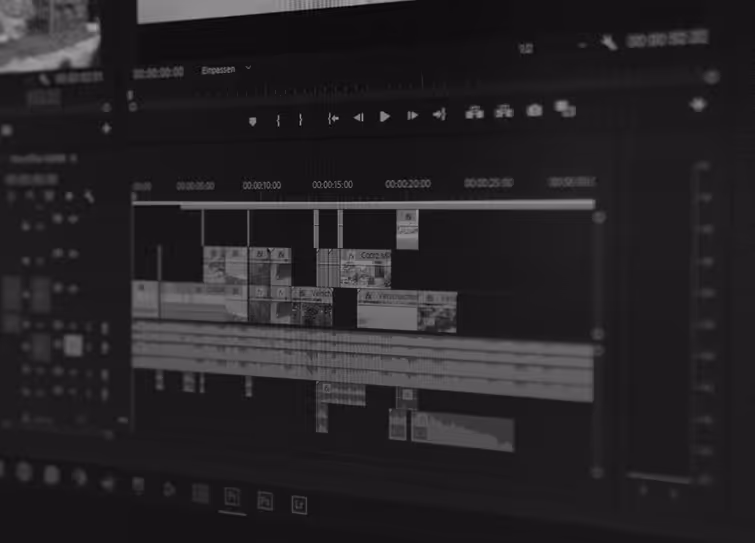 Close-up view of a computer screen showing a video editing timeline with multiple clips and audio tracks.
