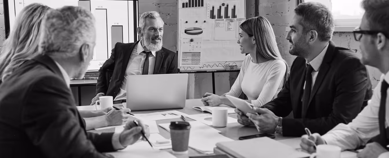 Business team in a meeting discussing charts and data in a modern office.