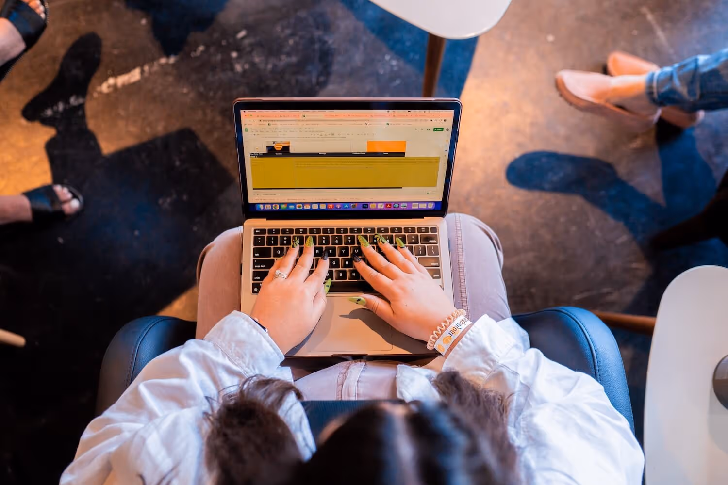 Hands of people analyzing business charts and graphs on a table with a coffee mug.