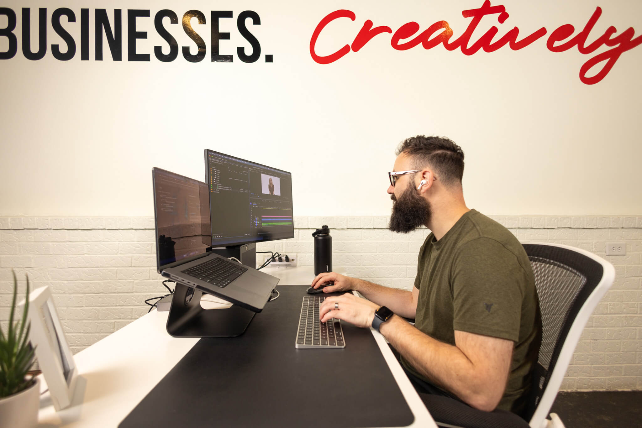 Woman presenting ideas on sticky notes to colleagues in a bright office meeting room.