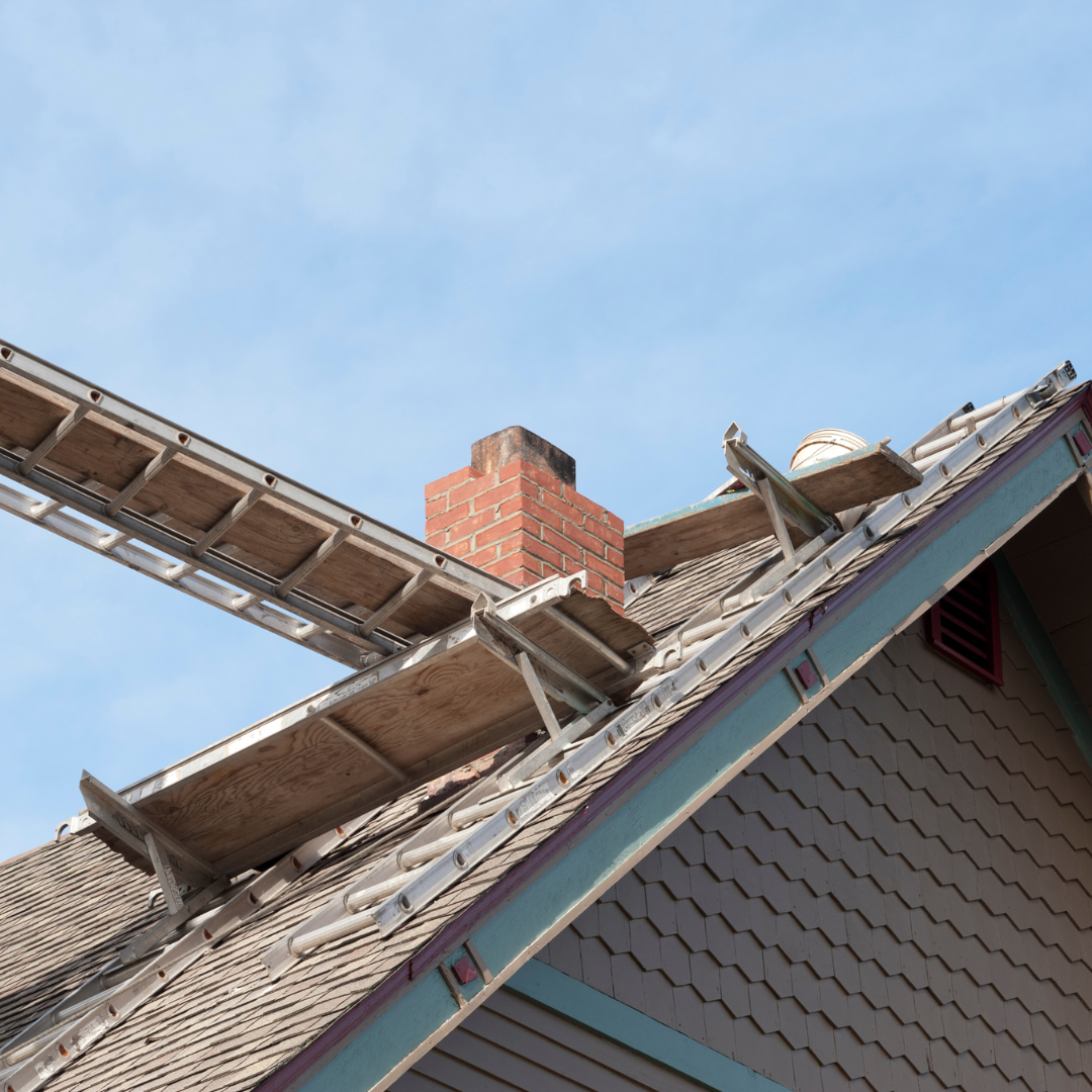 Professional chimney inspection access setup on residential roof with ladders positioned around brick chimney for spring masonry and fireplace evaluation in Chicagoland home exterior
