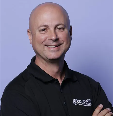 A man wearing a black shirt with a white logo.