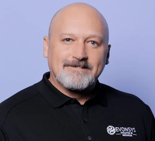 A man with a bald head and a goatee wearing a black shirt.