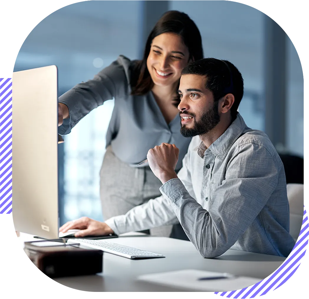 Woman pointing to a screen of a co-worker.