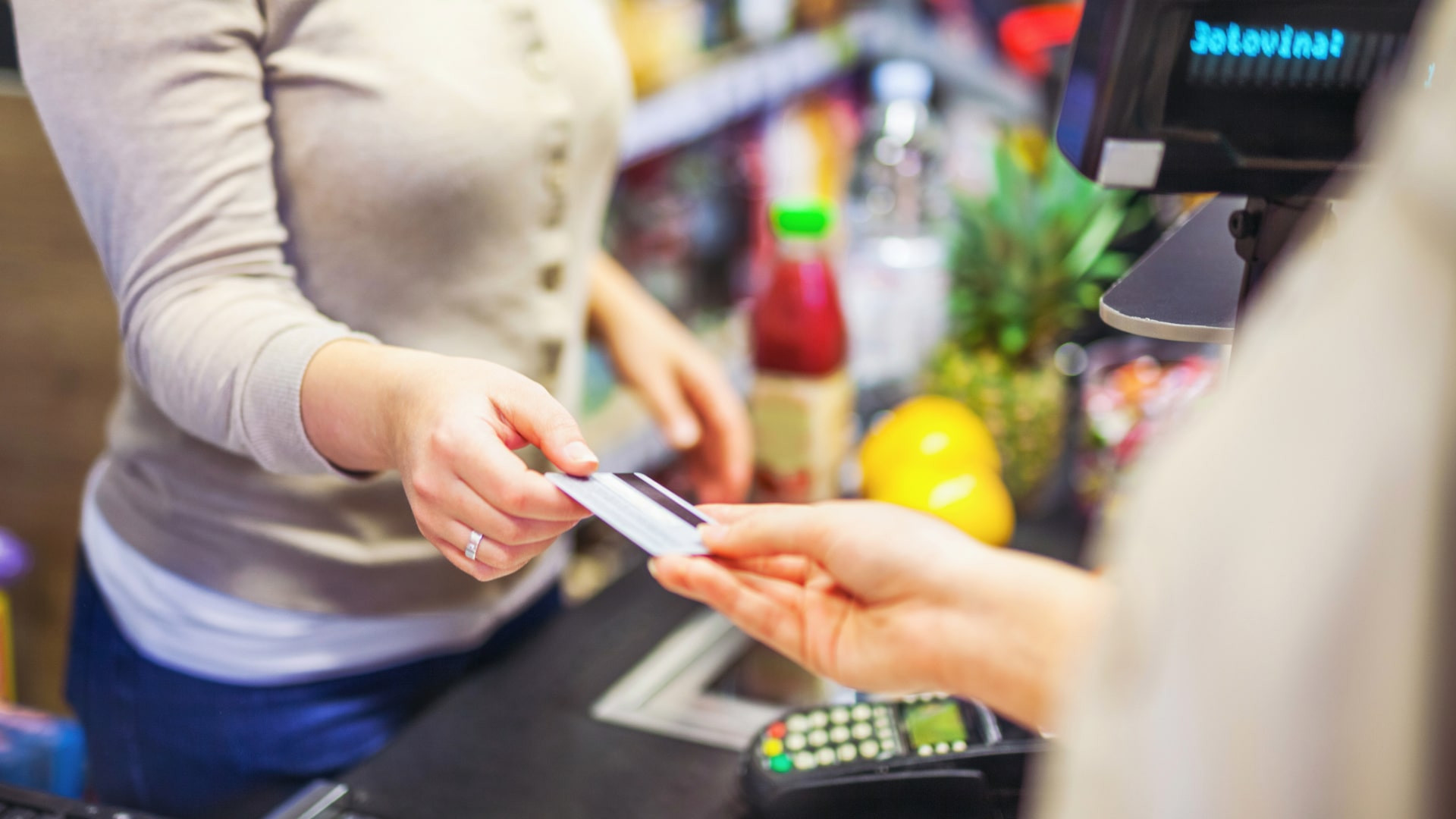 Woman paying for groceries with a SNAP benefits card