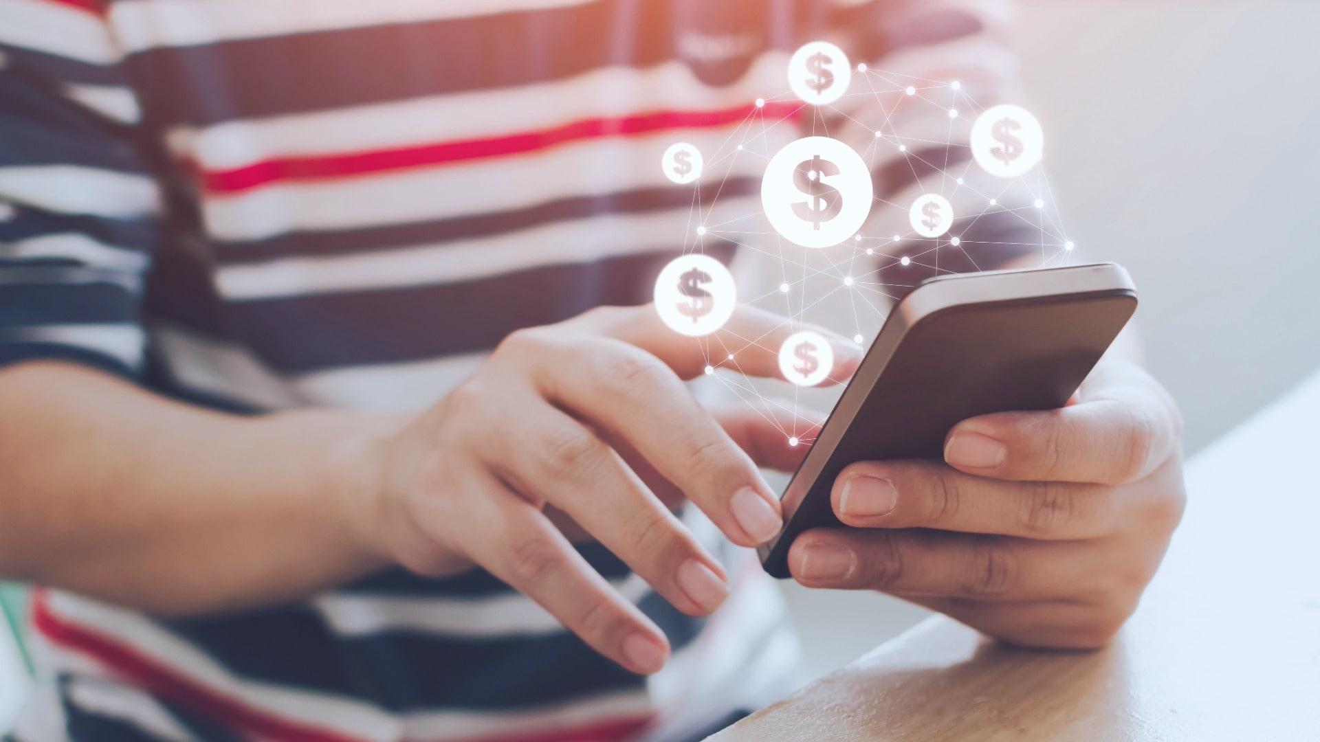 Person holding a cell phone using a payment app like Cash App to send money