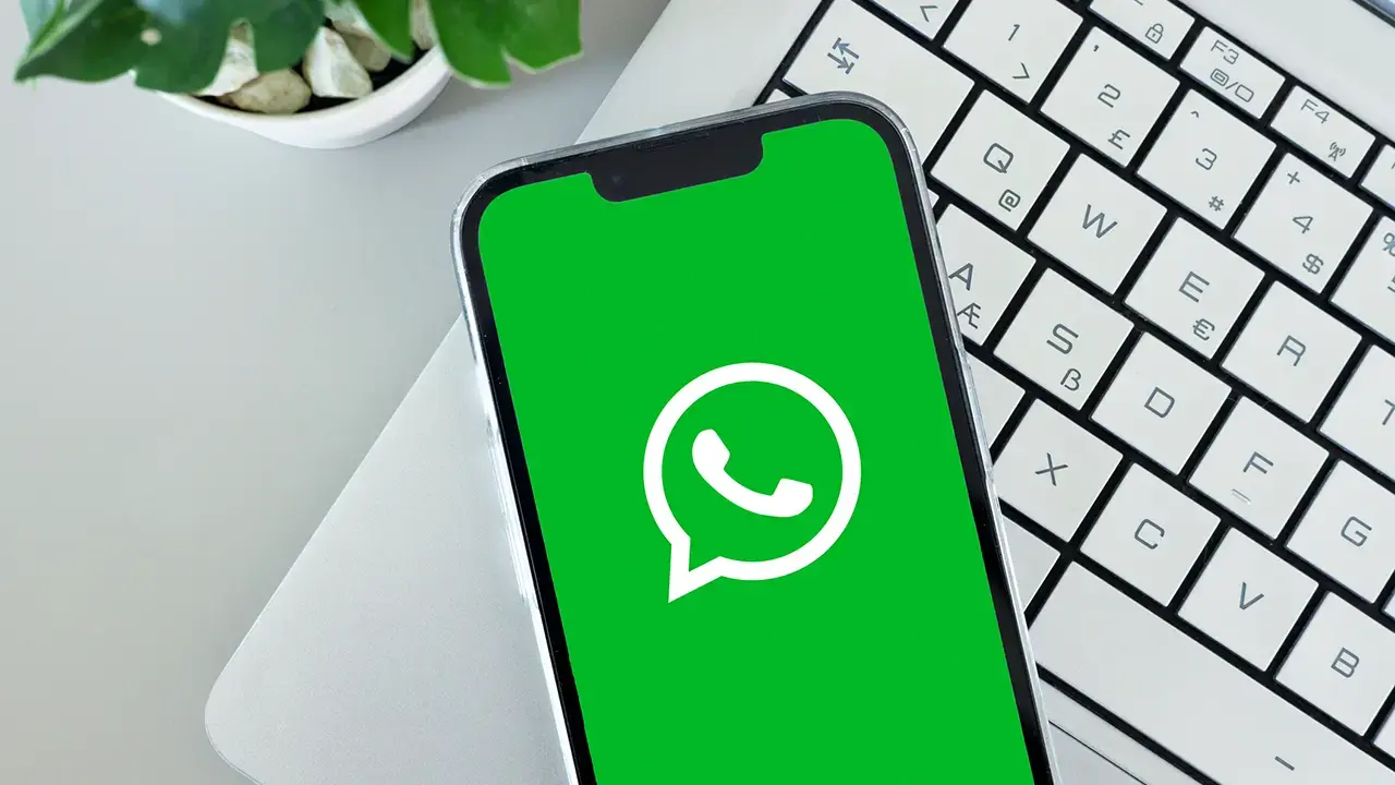 A WhatsApp message on a phone, representing the Booking.com hotel WhatsApp scam using stolen reservation data