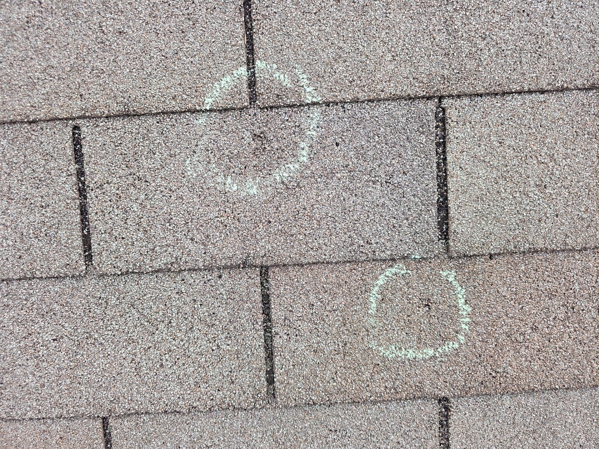Hail damage documented on a Minnetonka roof during a Storm Master insurance-claim inspection