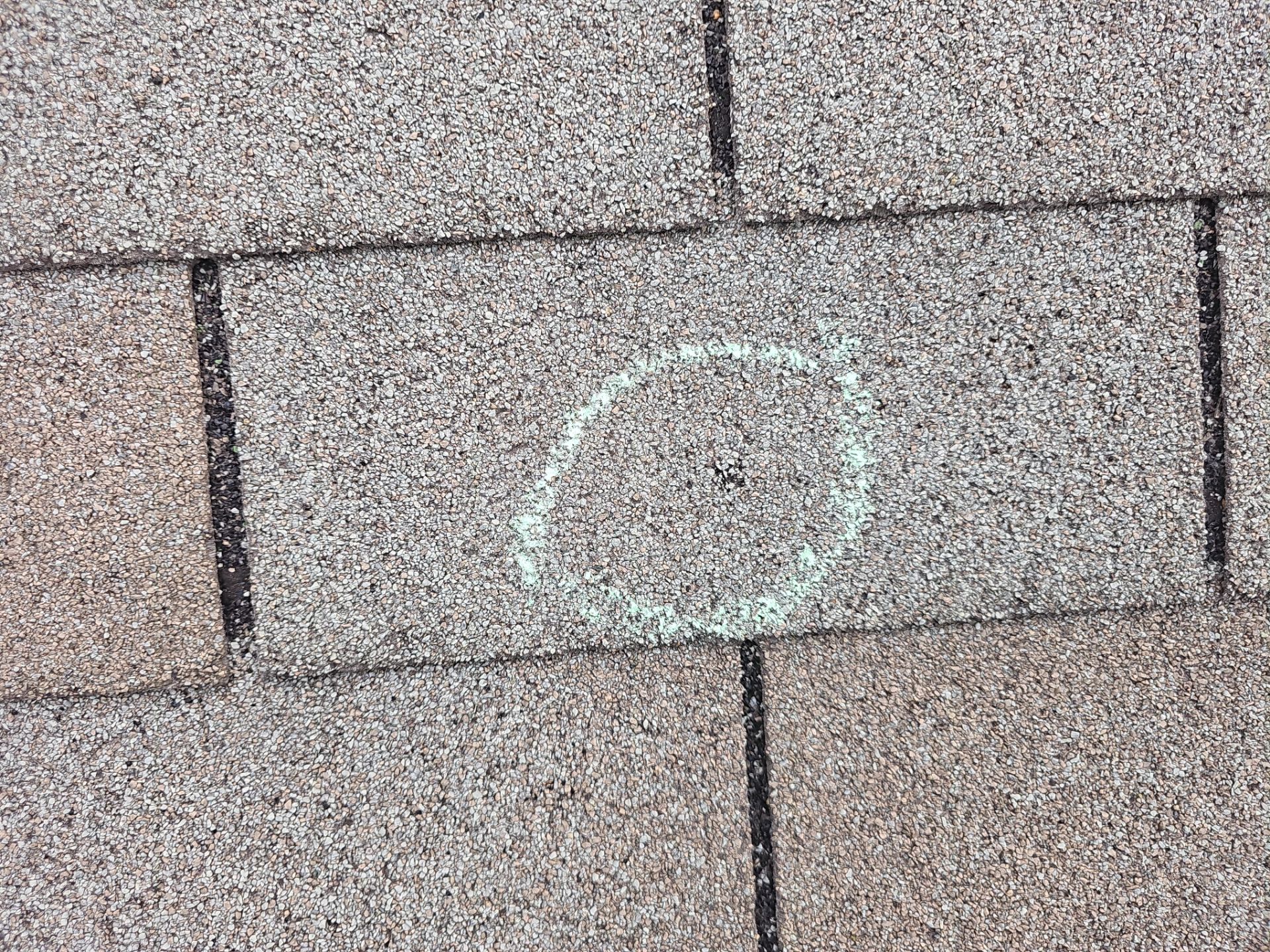Hail impact documented on a Minnetonka roof during a Storm Master insurance-claim inspection