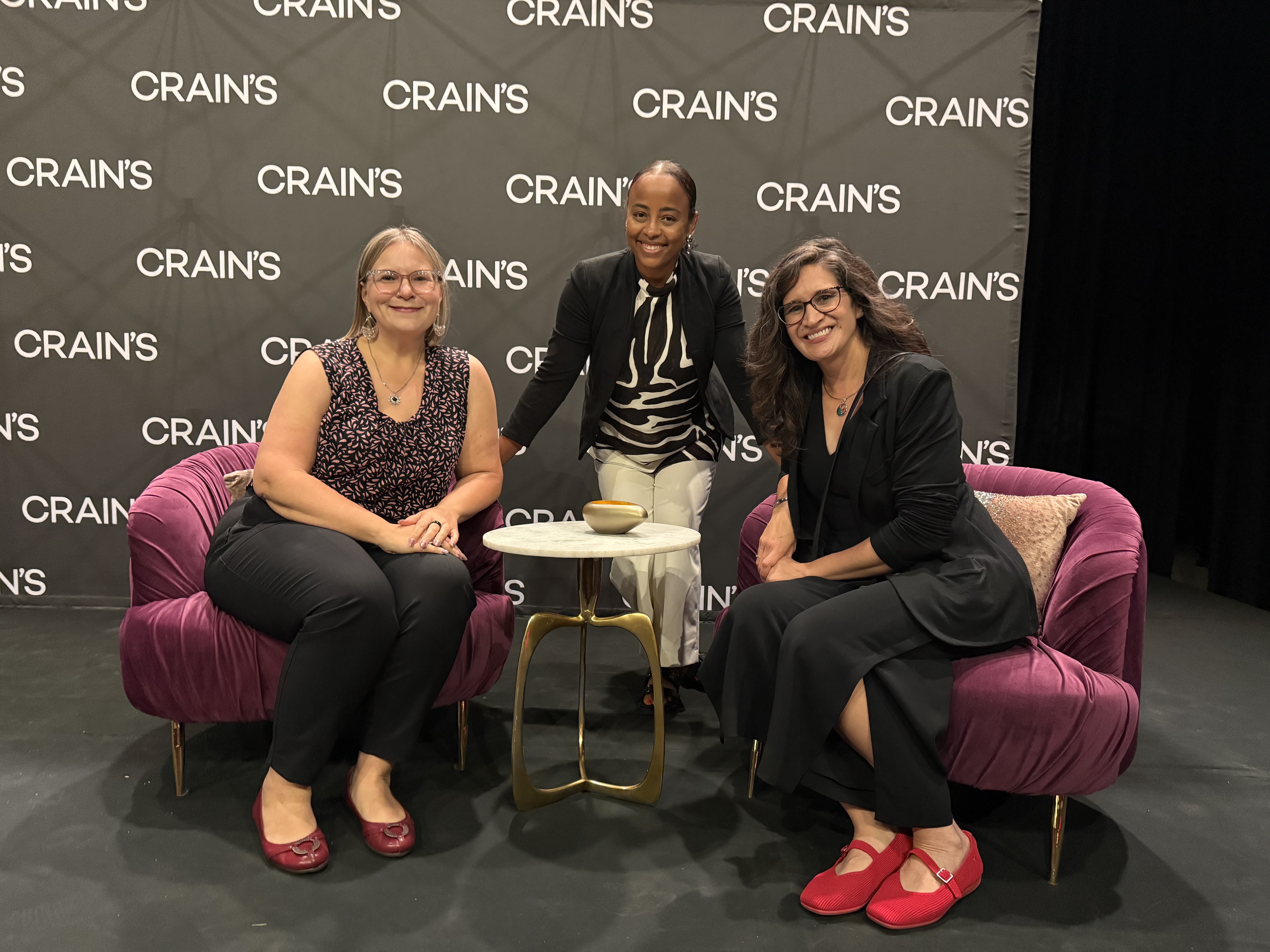 3 women infront of crain's chicago banner 