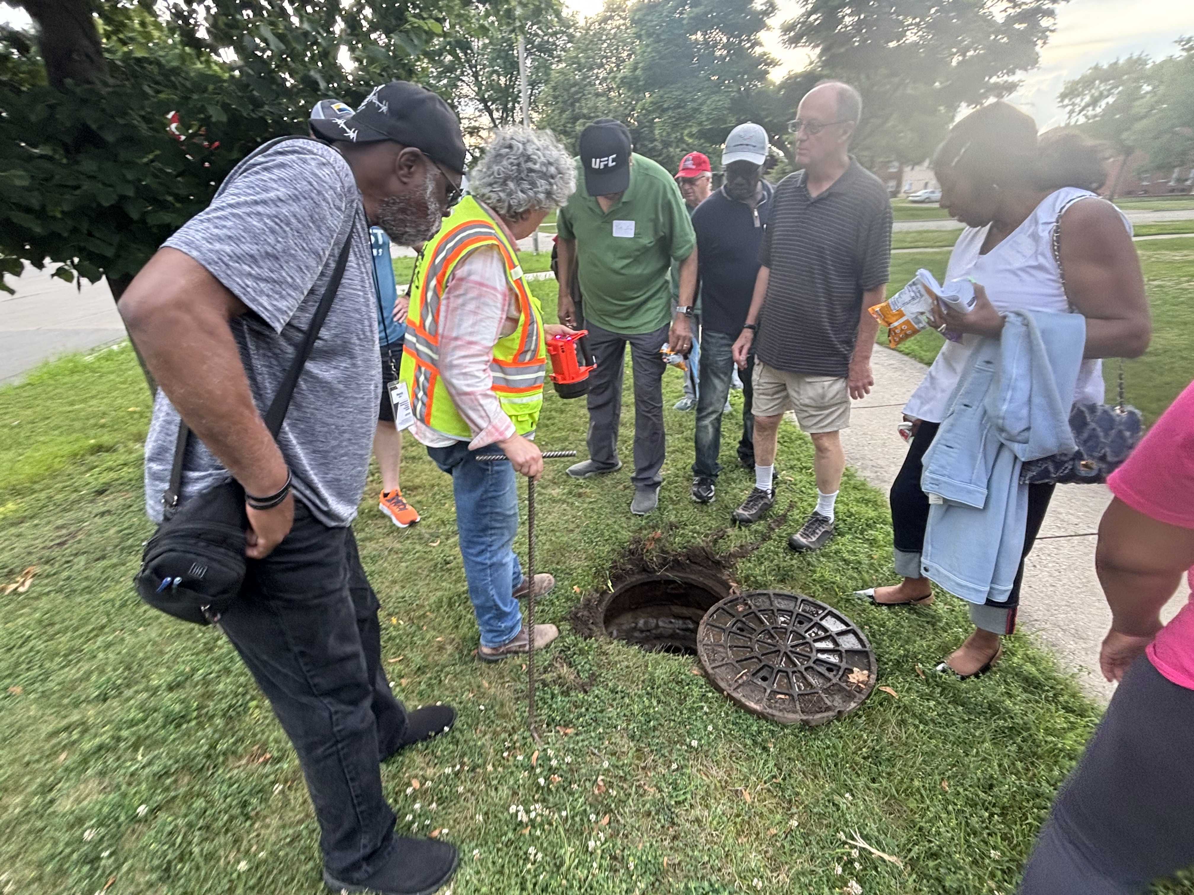 people looking into sewer