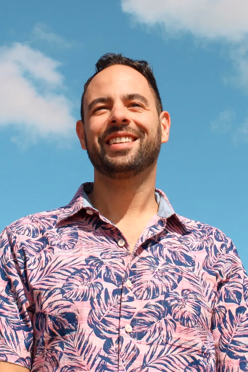 Wes of the GAS team smiling in a pink tropical shirt