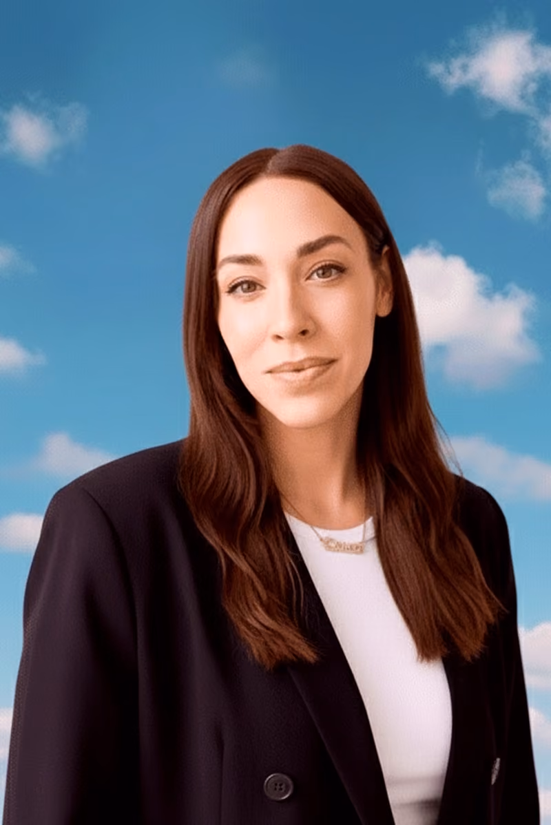 Lauren Richmond in a black blazer against a blue sky