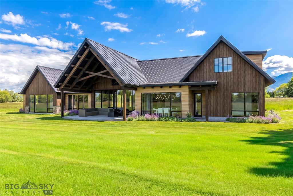 Rear patio and covered outdoor living space overlooking the pond