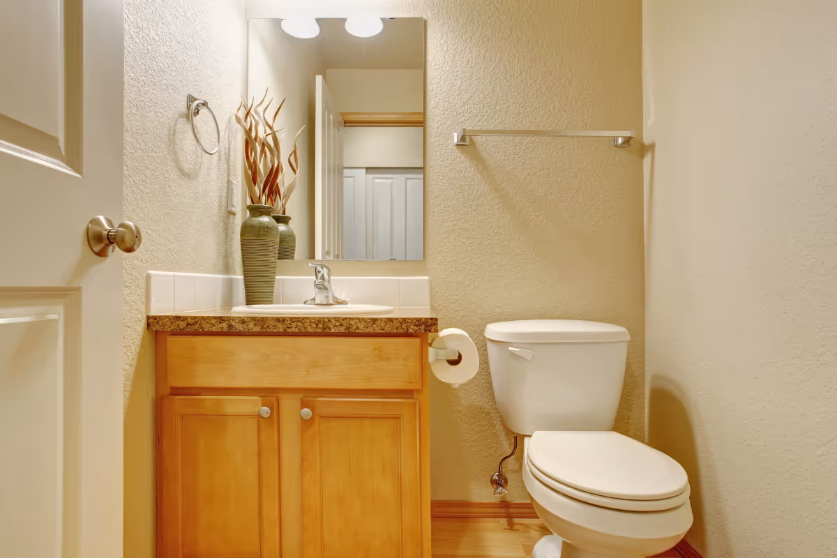 half bathroom layout with a toilet and sink