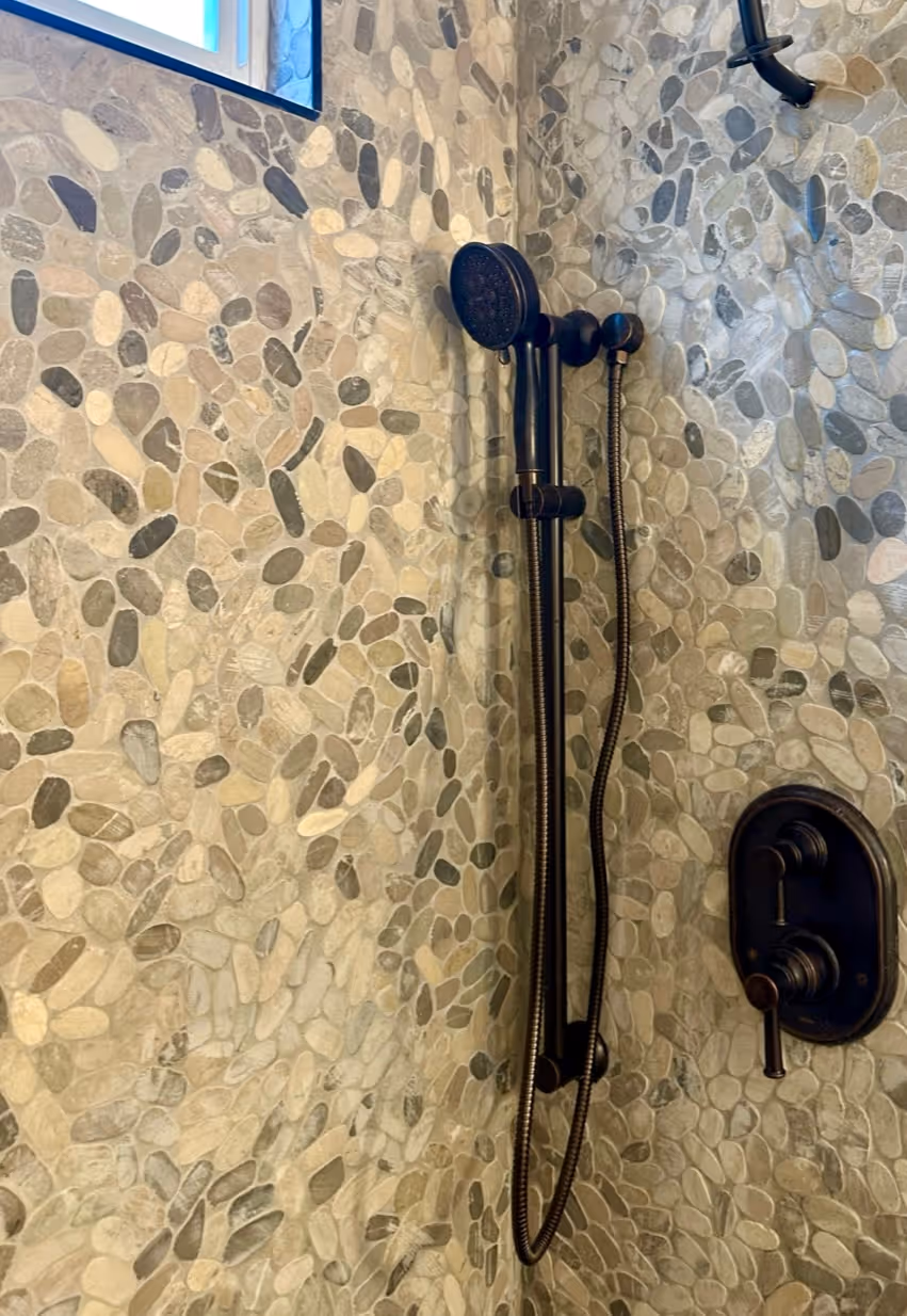 Coastal Bathroom with Pebble Mosaic Tile on Shower Wall