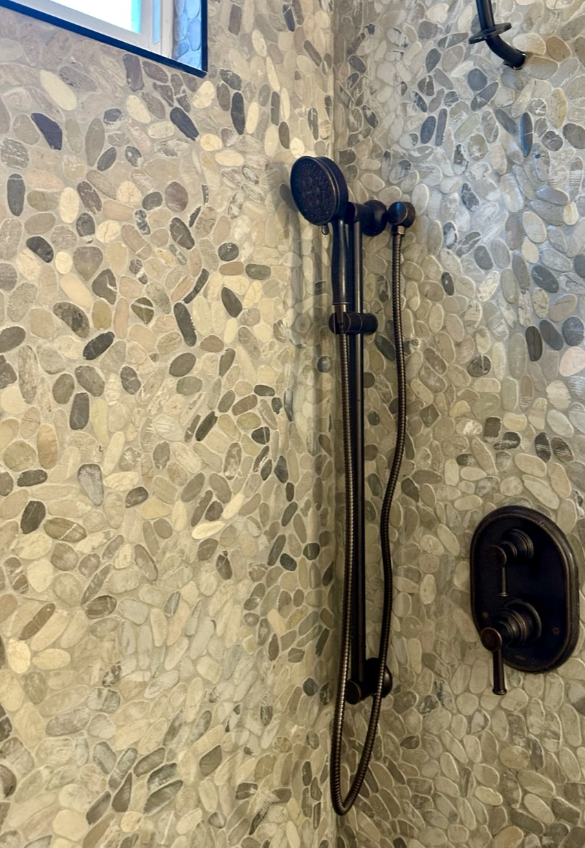 Coastal Bathroom with Pebble Mosaic Tile on Shower Wall