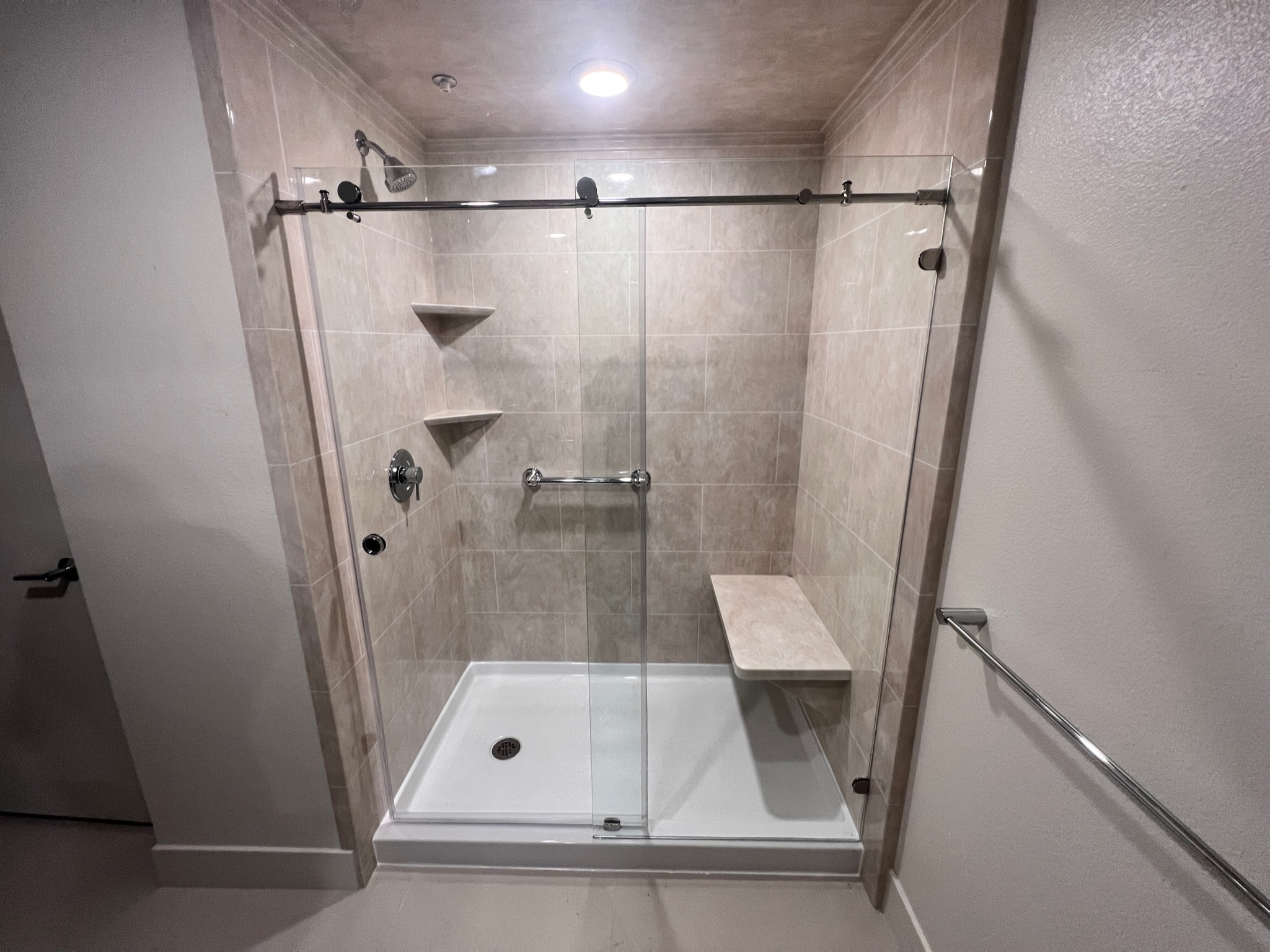 shower with natural ceramic tile wall 