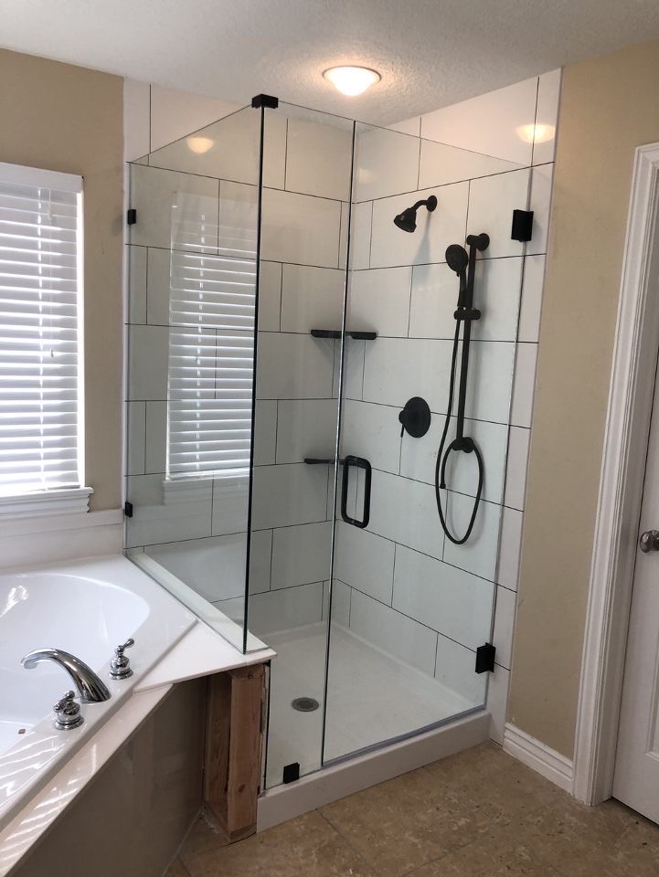 Glass Enclosed Shower with White Large Format Shower Tiles with Black Grout