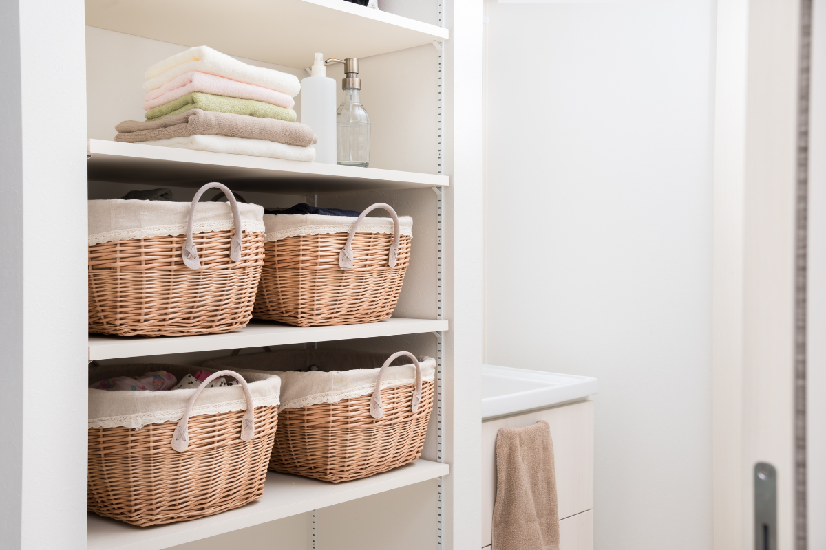 Bathroom with vertical storing shelves holding backets