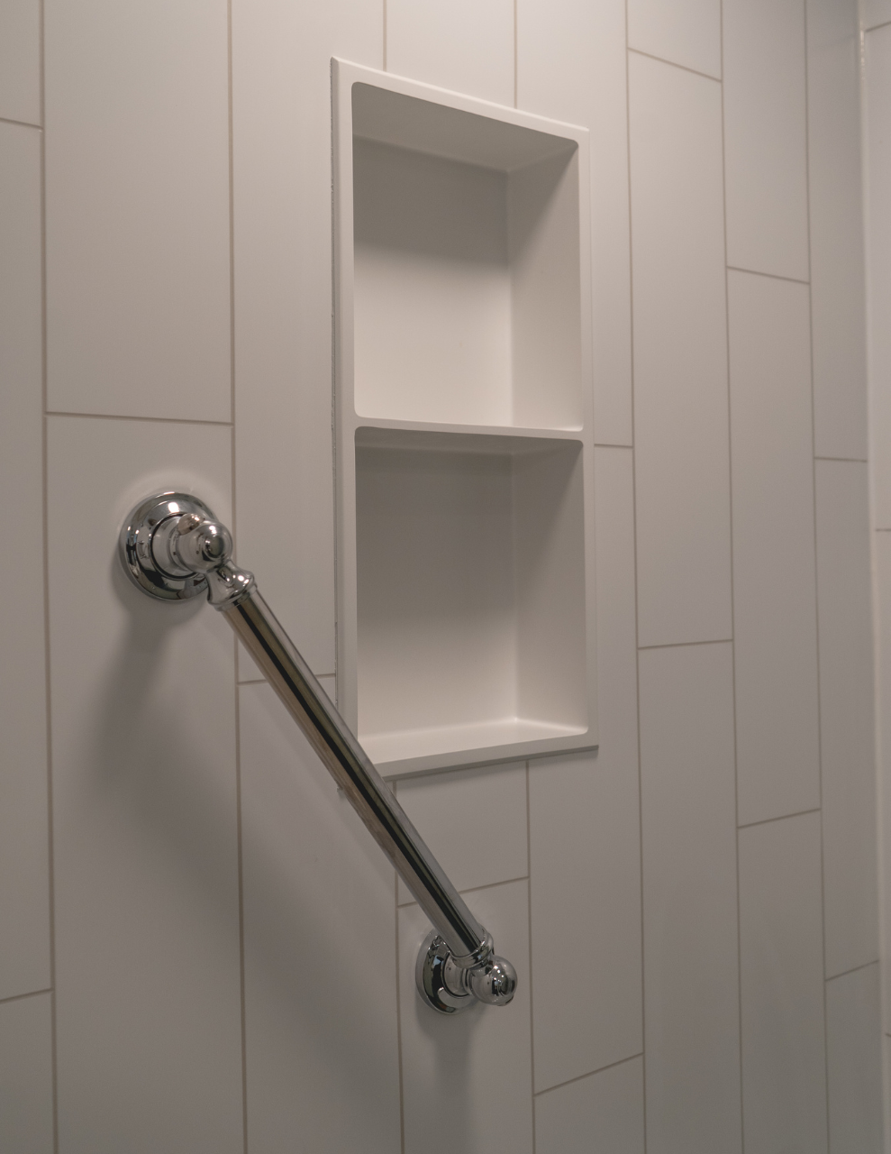 Walk-in Shower with silver Grab Bar and Built-In Shelving