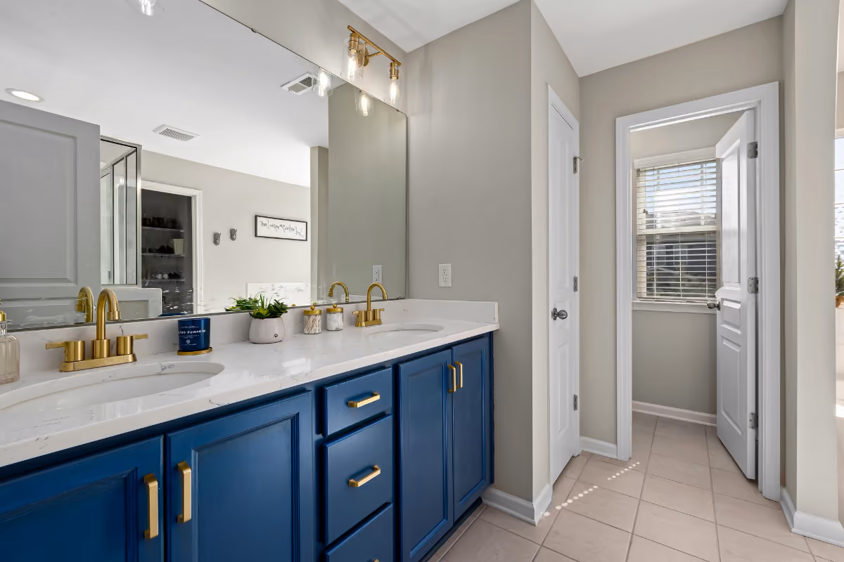 main bathroom double royal blue vanity with brass hardware