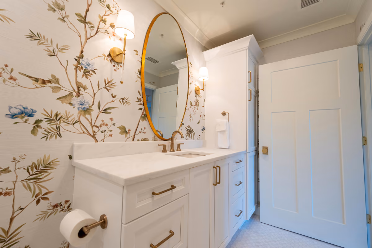 bathroom with white bathroom vanity and tree wallpaper