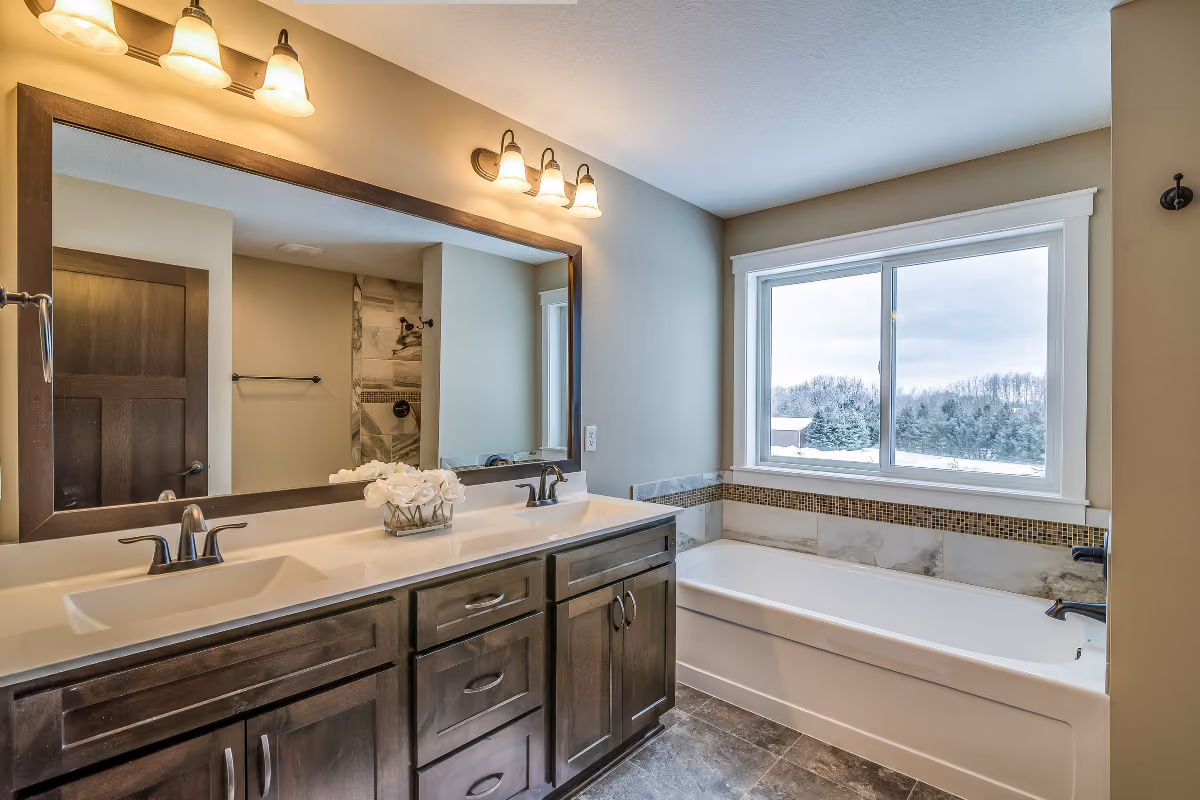 bathroom with dark wooden double vanity and tub 