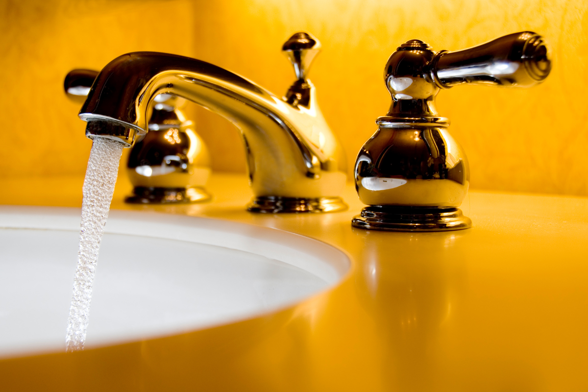 lever handle faucet in yellow bathroom 