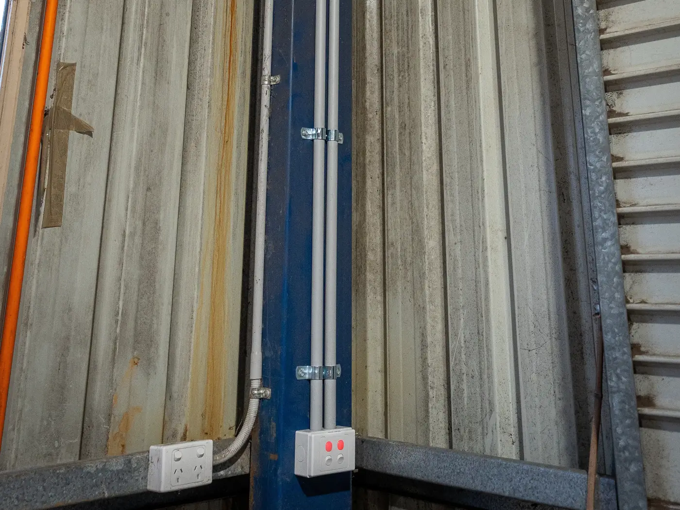 Conduit and weatherproof power points on the potting shed wall at ProteaFlora