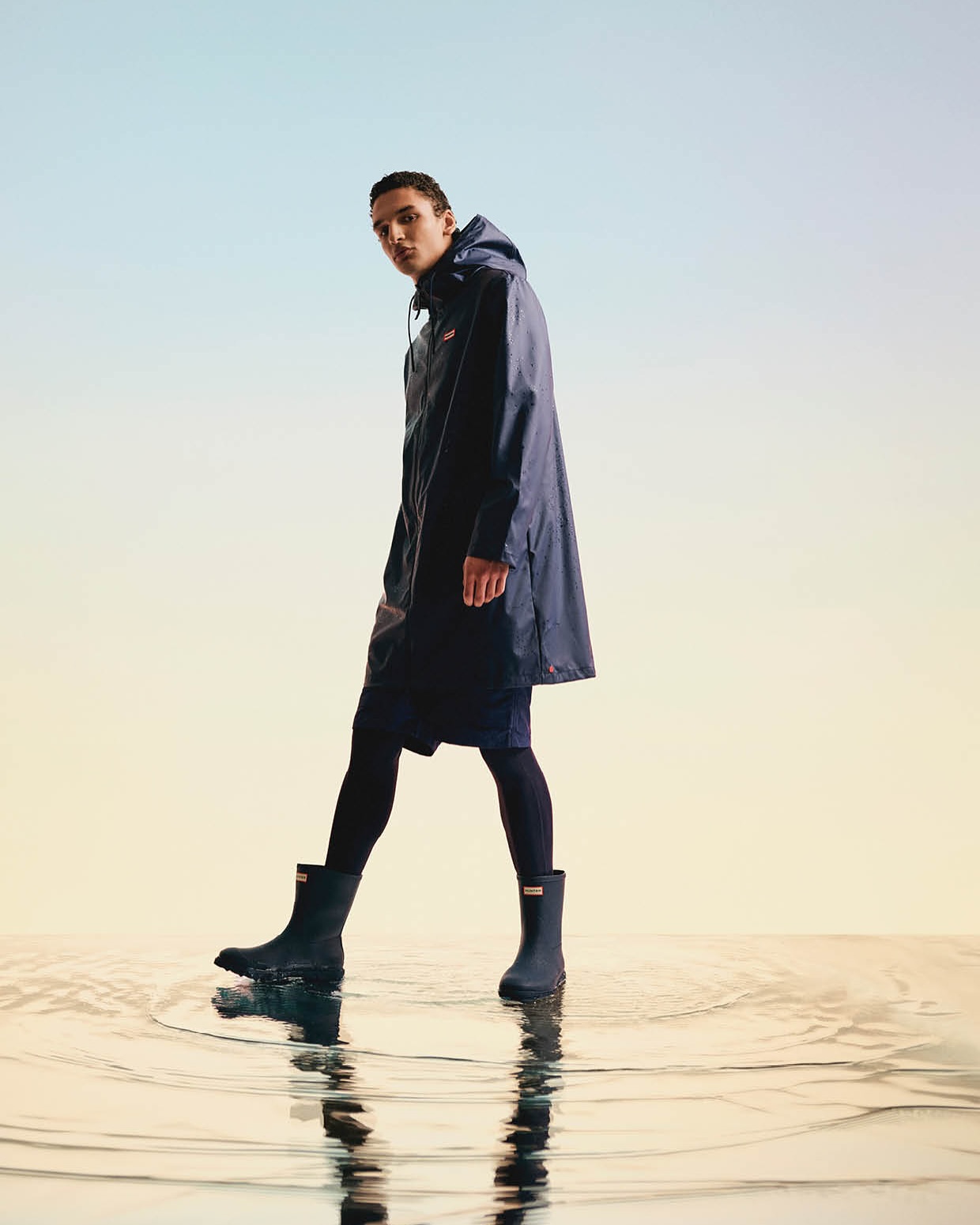 Hunter Downpour men’s rainwear campaign featuring lightweight navy waterproof jacket.