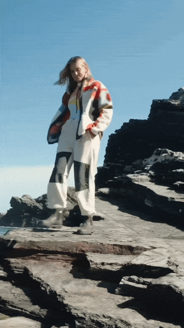 Outdoor swimmer wearing a colorful fleece jacket after a cold-water swim, part of Speedo Outsiders Club campaign.