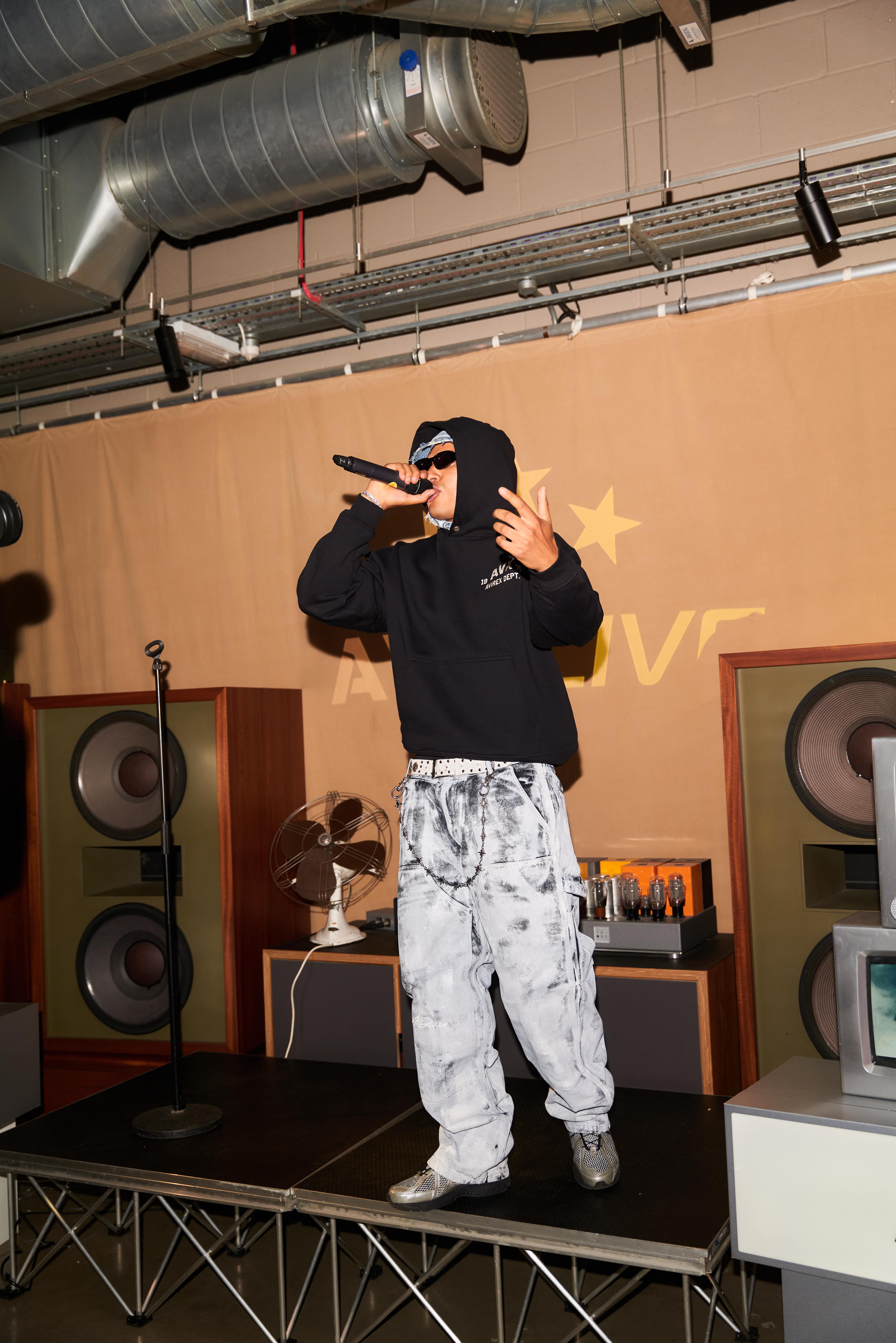 AntsLive performing wearing AVX hoodie on stage entertaining crowd during AVX Live launch event.