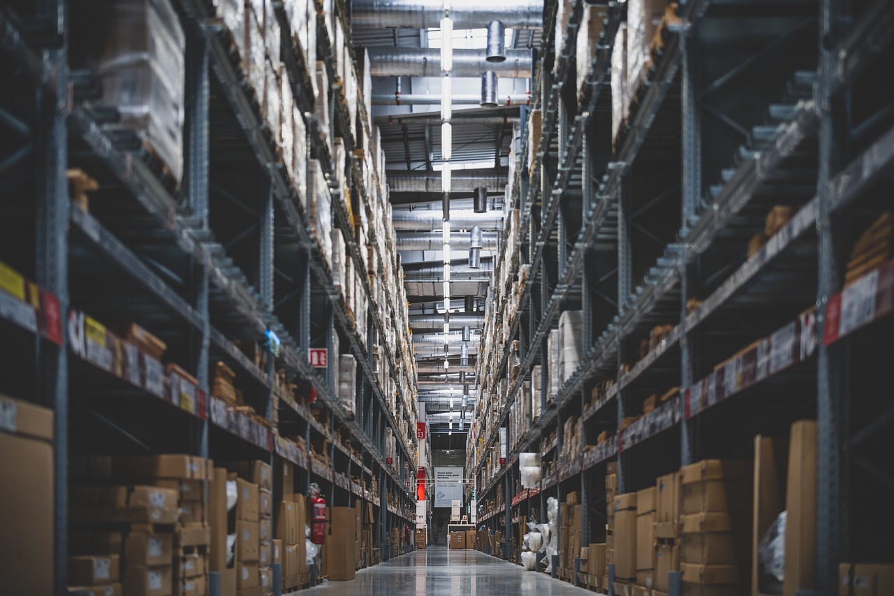 View inside a busy warehouse showing several racks full with pallets