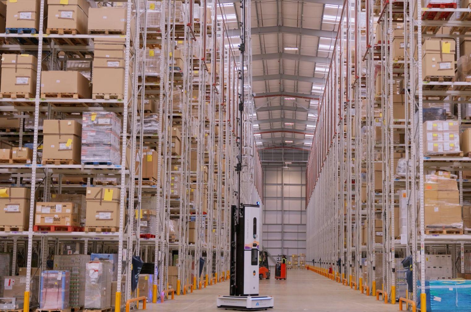 Dexory's autonomous robot scanning warehouse pallet locations, capturing data for real-time insights and accuracy in dynamic, multi-customer environments