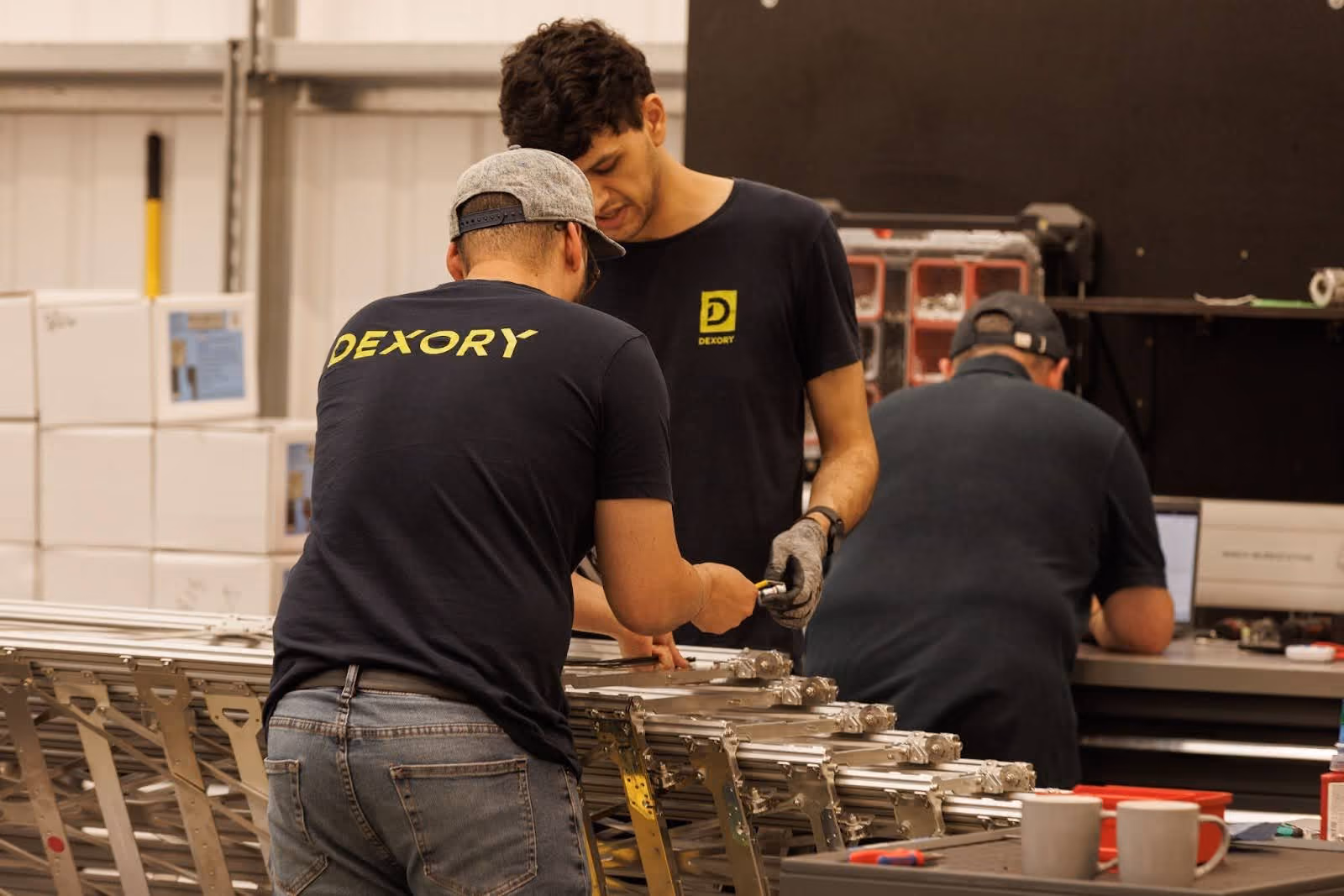 Dexory workers instrumenting parts on a production line in a factory