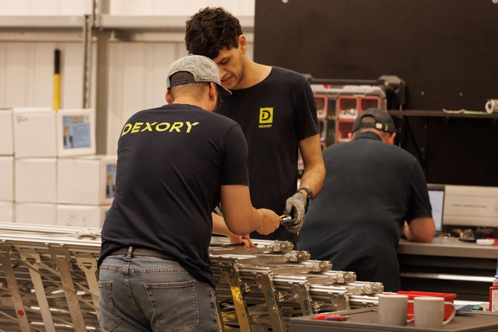 Dexory workers instrumenting parts on a production line in a factory