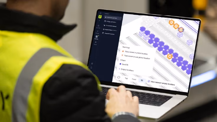 Warehouse operative using DexoryView Optimise platform to analyse warehouse slotting, space utilisation and inventory location data to transform warehouse operations.