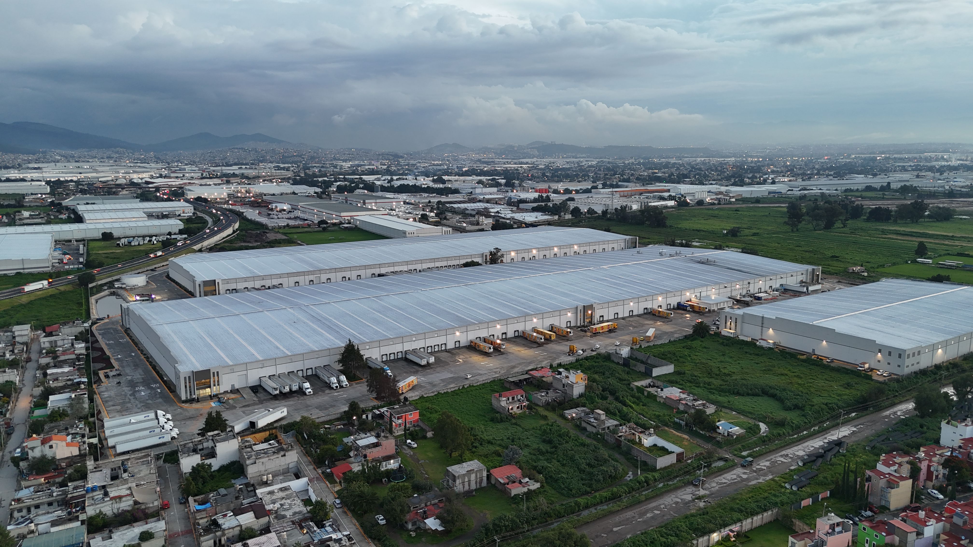 Aerial view of a large-scale warehouse distribution complex, representing the operational scale at which small inventory errors compound into significant hidden warehouse costs and financial impact.