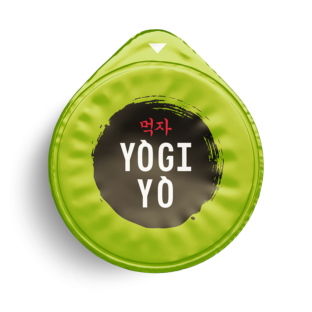 Green circular lid with a black brushstroke design in the center and white text reading 'YOGI YO' with red Korean characters above.