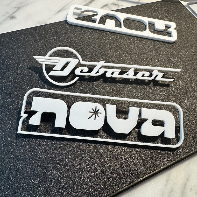 White plastic cutout letters spelling 'Debaser' and 'nova' on a black textured surface, with 'nova' enclosed in a rounded rectangle and featuring a star symbol inside the letter 'o'.