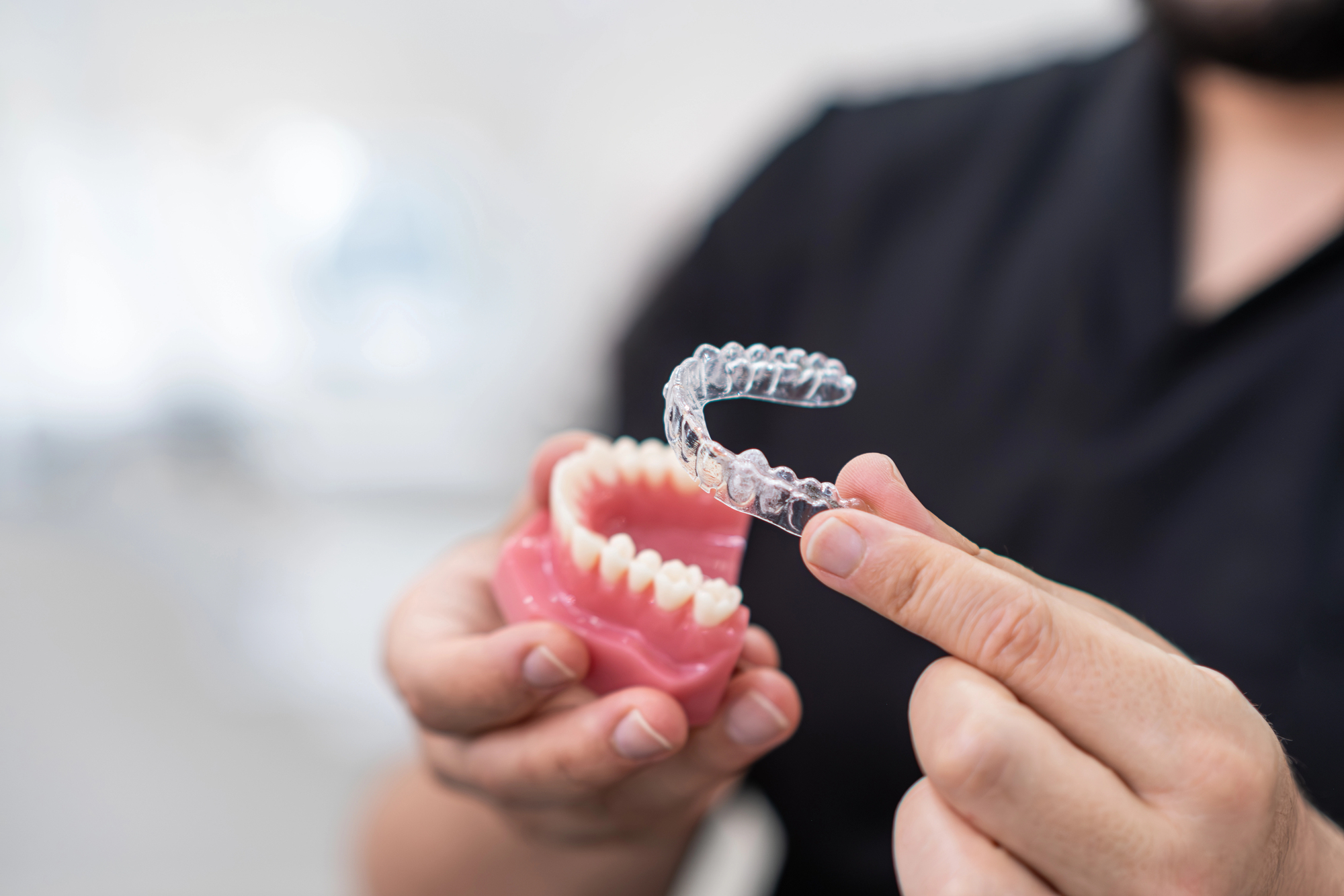 dentist from chesapeake comprehensive dentistry holds clear aligner