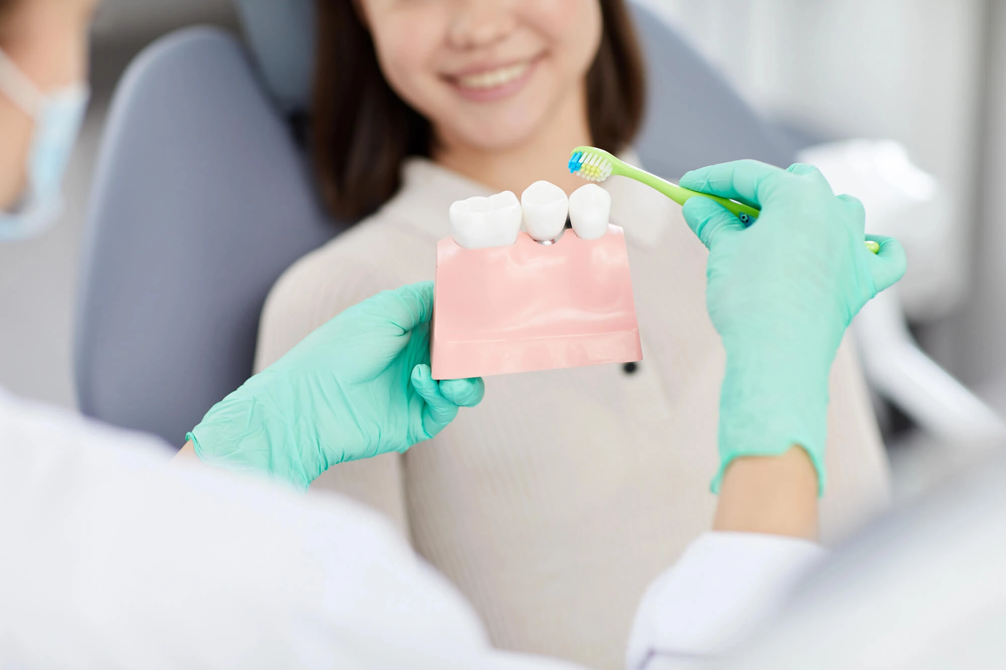 Dentist showing how to brush dental implants Chesapeake VA