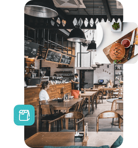 Modern café interior with wooden tables, chairs, hanging lights, and a burger on a cutting board in the foreground.