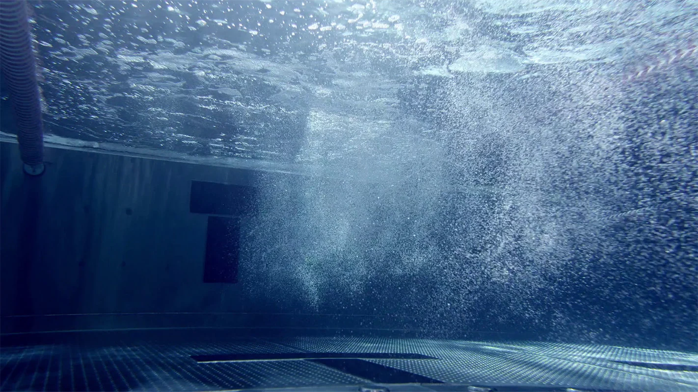 Imagefilm der Filmproduktion Panda Pictures aus München und Ulm für Speedo. Eine Unterwasseraufnahme zeigt aufgewühltes Wasser und viele Blasen, welche die Wasserdynamik in dieser abstrakten Einstellung verdeutlichen.