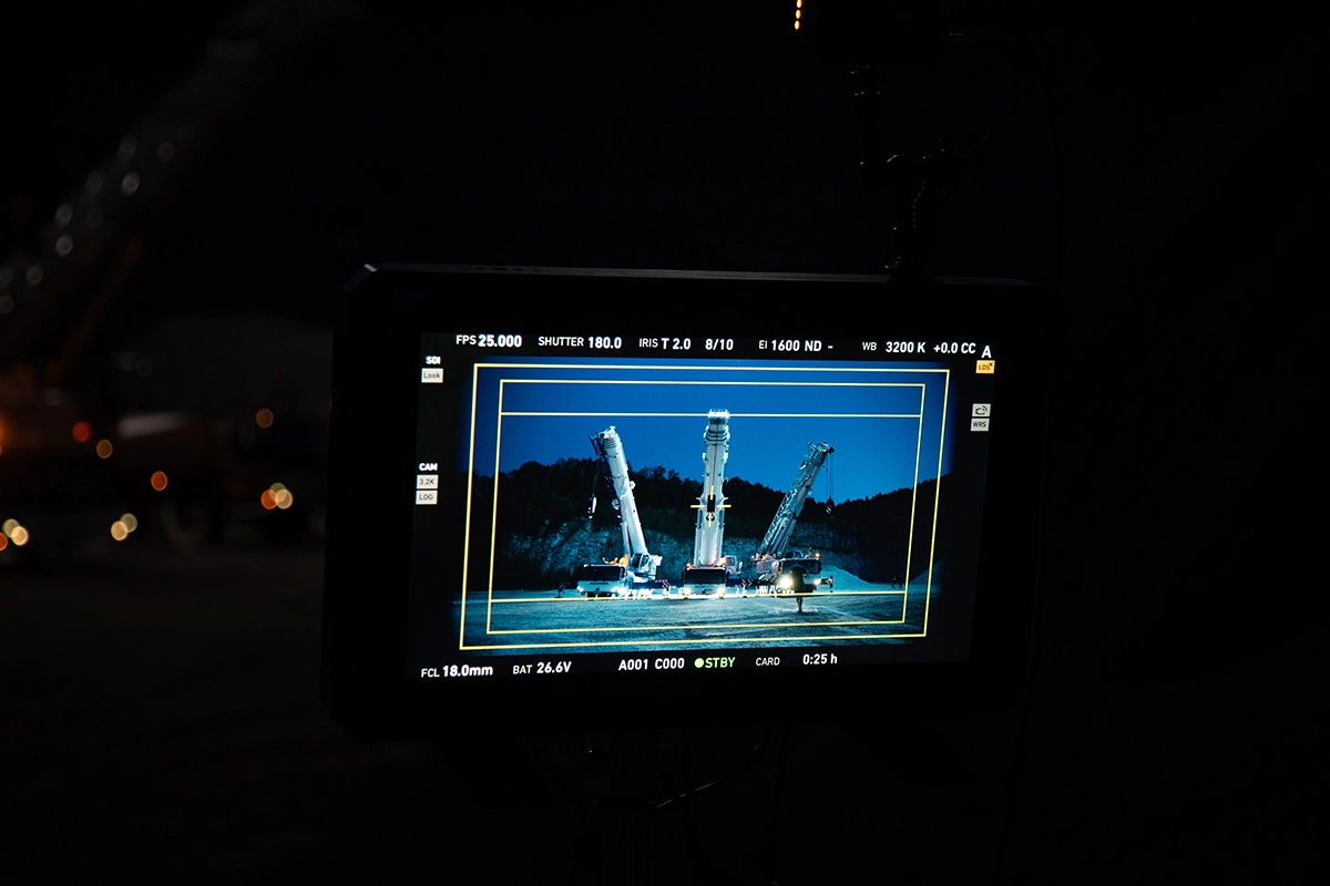 Imagefilm der Filmproduktion Panda Pictures aus München und Ulm für Maxikraft. Ein externer Vorschaumonitor zeigt das Bild einer nächtlichen Szene mit Kränen, auf dem alle wichtigen Kameraeinstellungen für den Kameramann ablesbar sind.