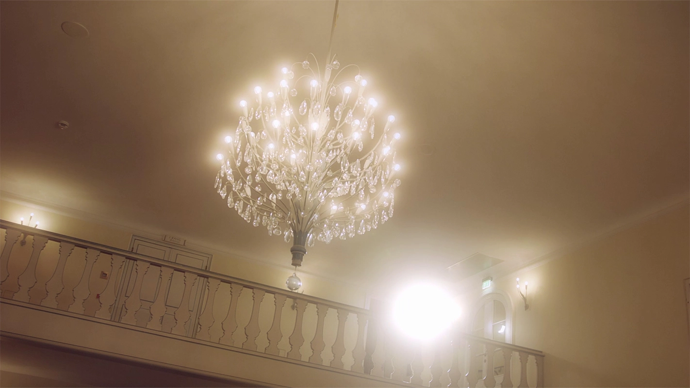 Weihnachtsfilm der Filmproduktion Panda Pictures aus München und Ulm für UniCredit. Ein glitzernder Kronleuchter in einem eleganten Saal, dessen warmes Licht die festliche Atmosphäre der Event-Dokumentation unterstreicht.