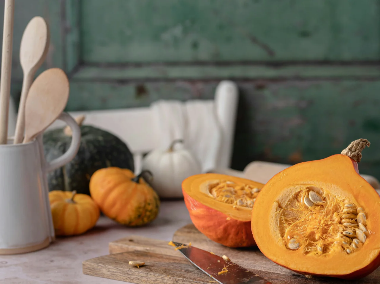 Small pie pumpkins on a cutting board ready to roast for homemade dog-safe puree