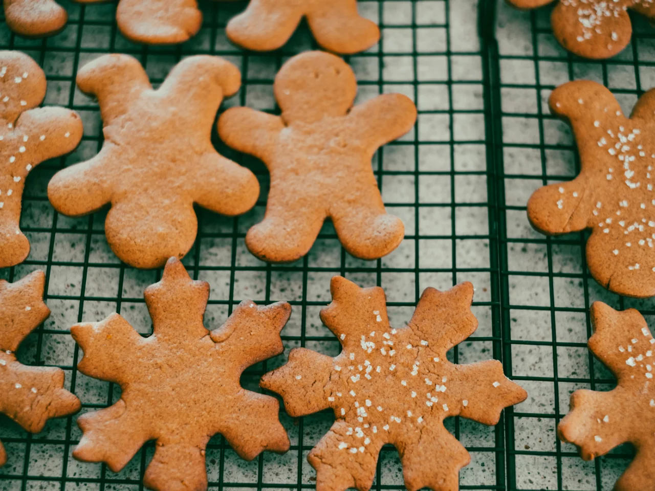 Holiday cookies cooling on a rack, which may contain nuts, chocolate, or raisins