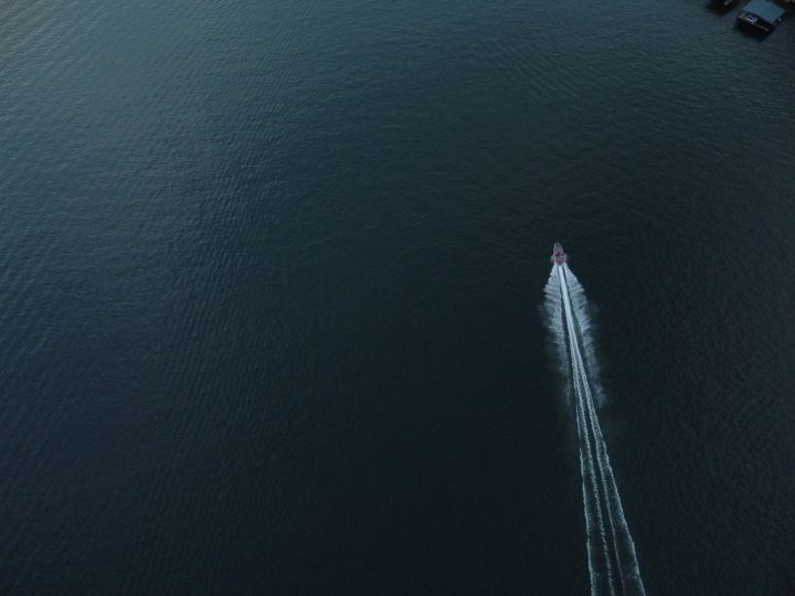 A boat is on the water in the ocean.